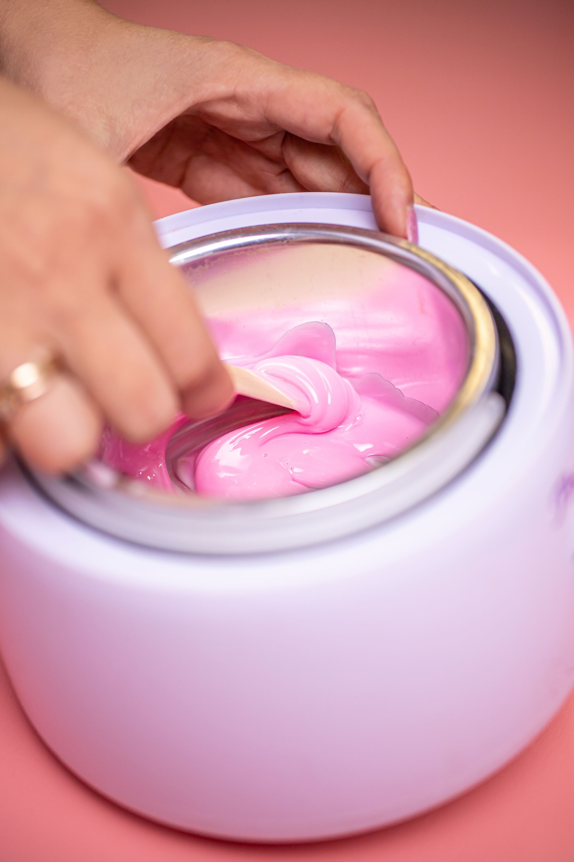 Wax in a heating container. Hot wax for depilation and preparing it in a special device